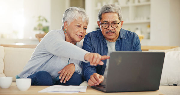 Retired couple reviewing reverse mortgage options