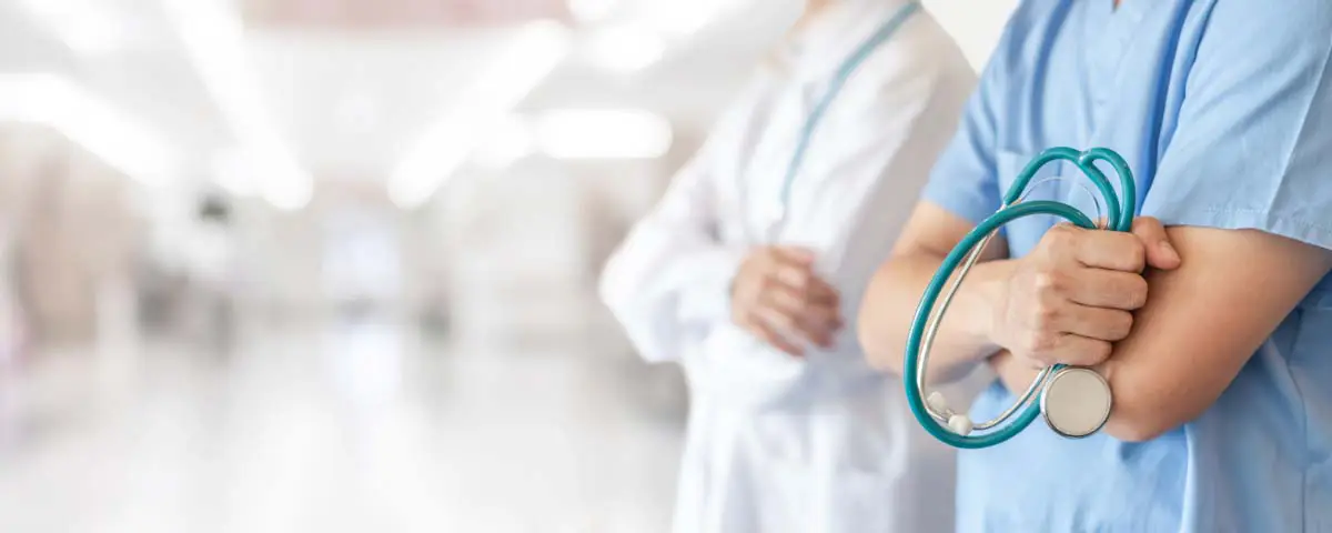 Medical professionals in scrubs and a lab coat