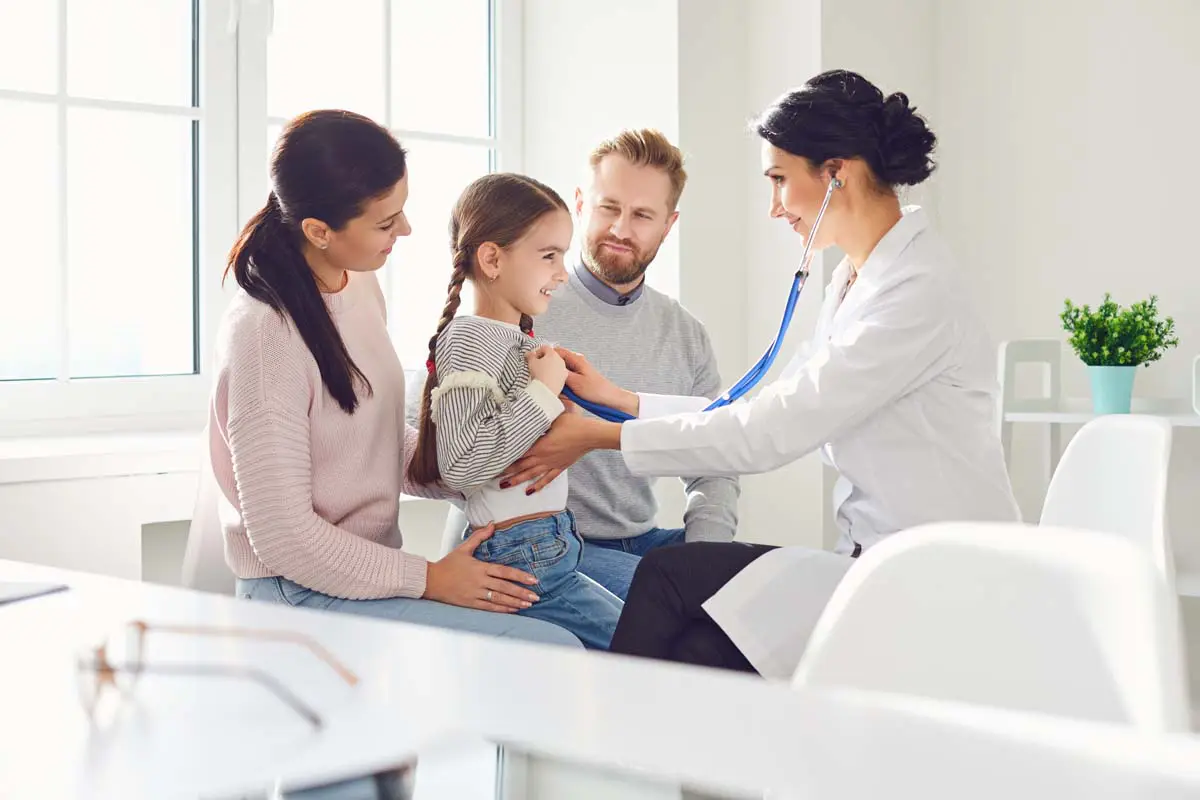 Female doctor with a family in a medical office