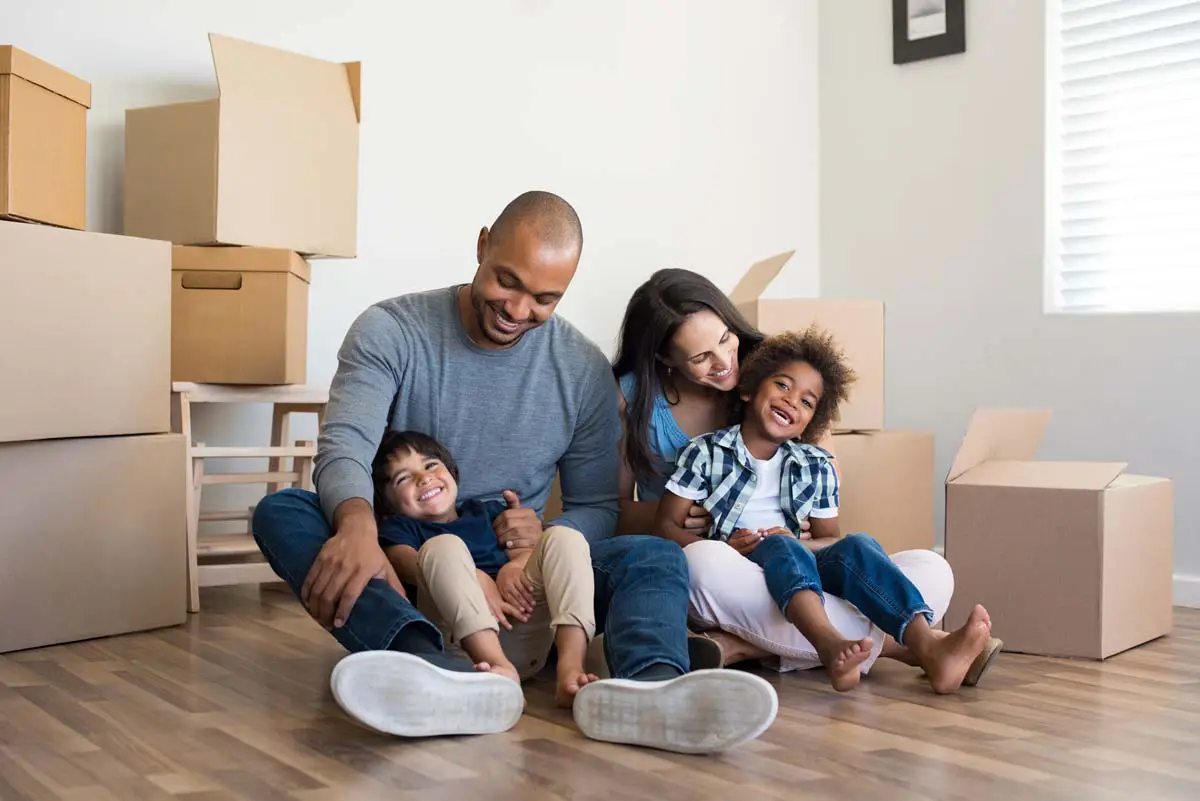 Family with moving boxes starting a new chapter