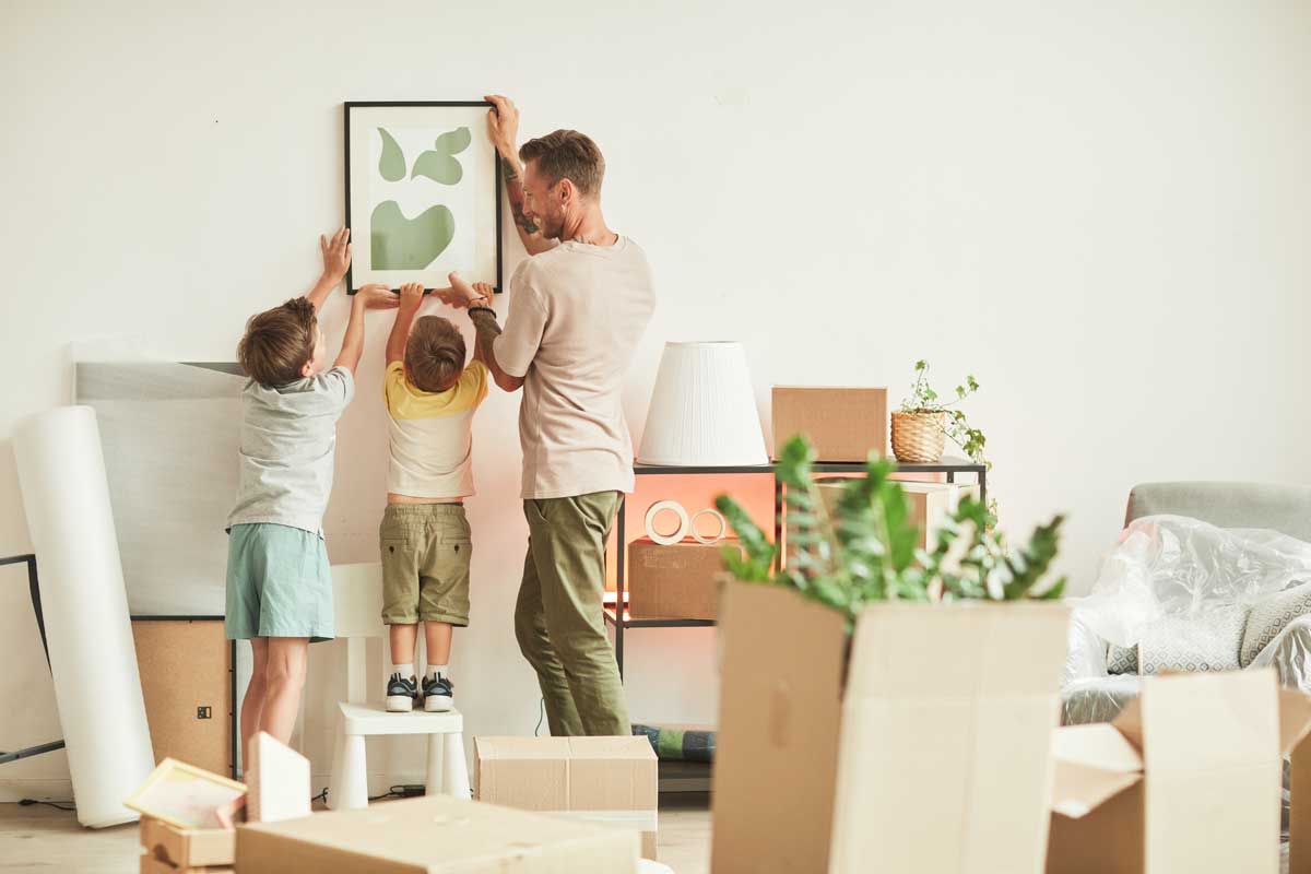 Family hanging a picture after home improvements