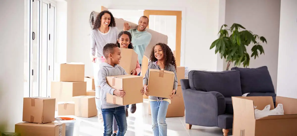 Family with moving boxes preparing for homeownership