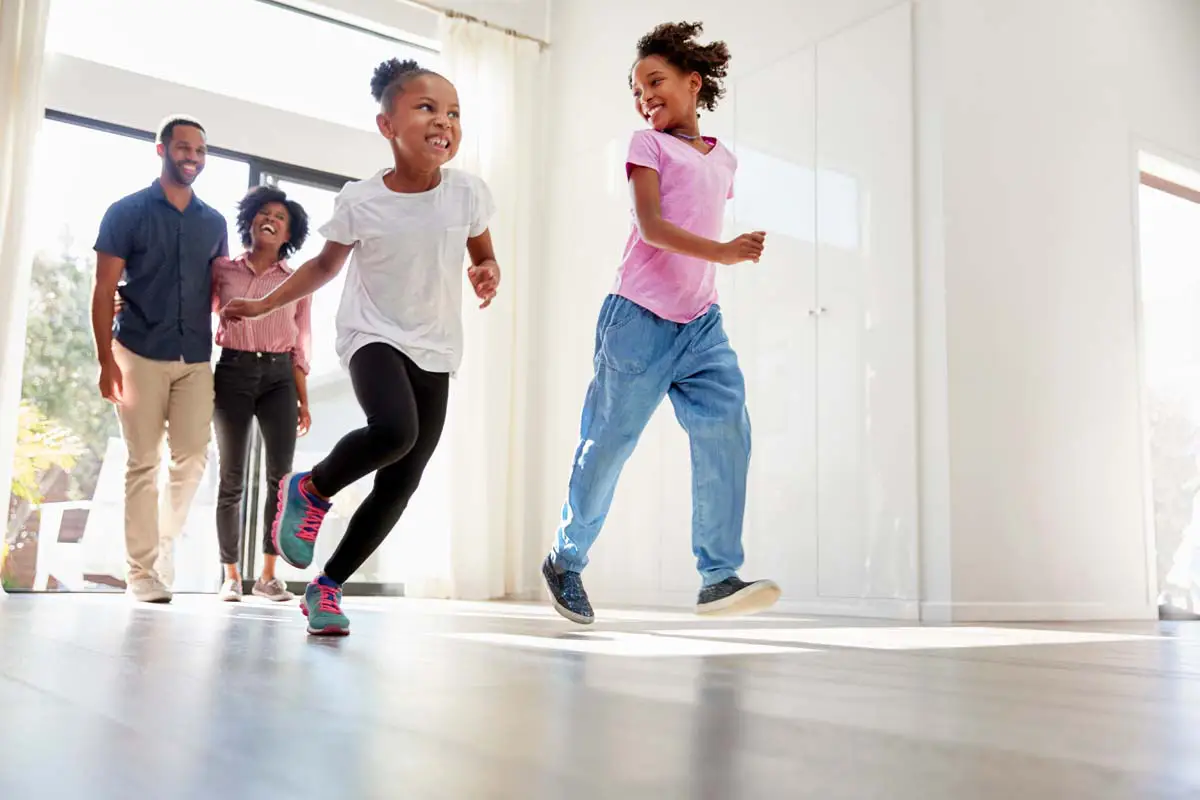Kids running and playing near their family home
