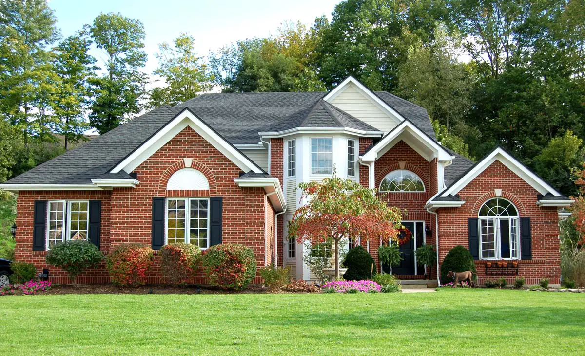 Large brick home with landscaped front yard